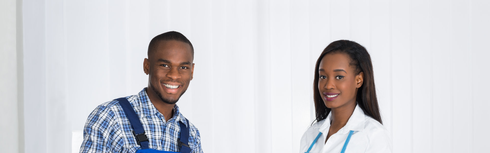 A man and woman in front of a plain white wall