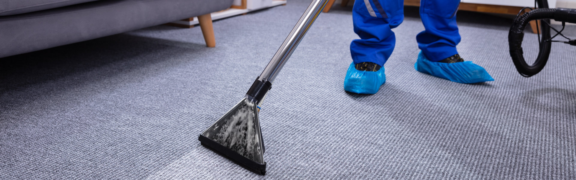 Person vacuuming the carpet